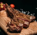 Sliced Ã¢â¬â¹Ã¢â¬â¹grilled beef steak tomahawk on a board, medium rare, close-up